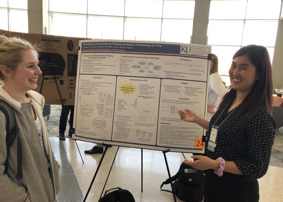 Students Brooke Lovrien (left) and Jennifer Chen (right) discussing ideas during a poster presentation at KU.