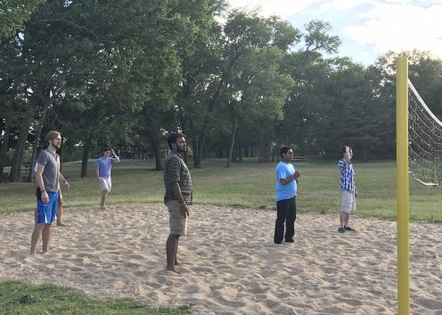 Students playing a volleyball match.